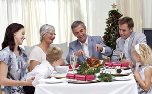 Family eating turkey in Christmas Eve at home