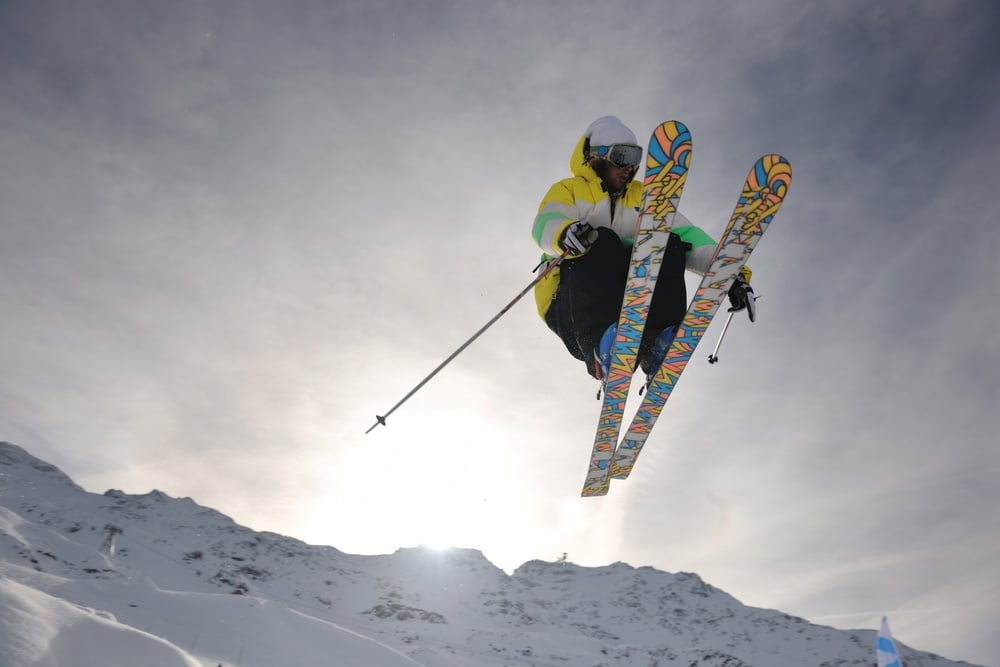 extreme freestyle ski jump with young man at mountain in snow park at winter season-1